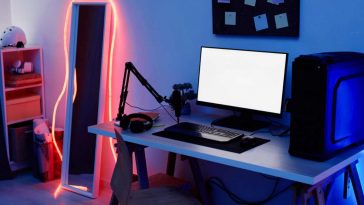 una scrivania da gaming con monitor e luci a led